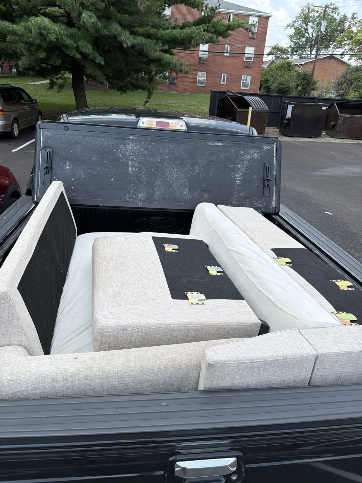 The same sectional couch broken down and loaded in the Cardinals Haul truck bed